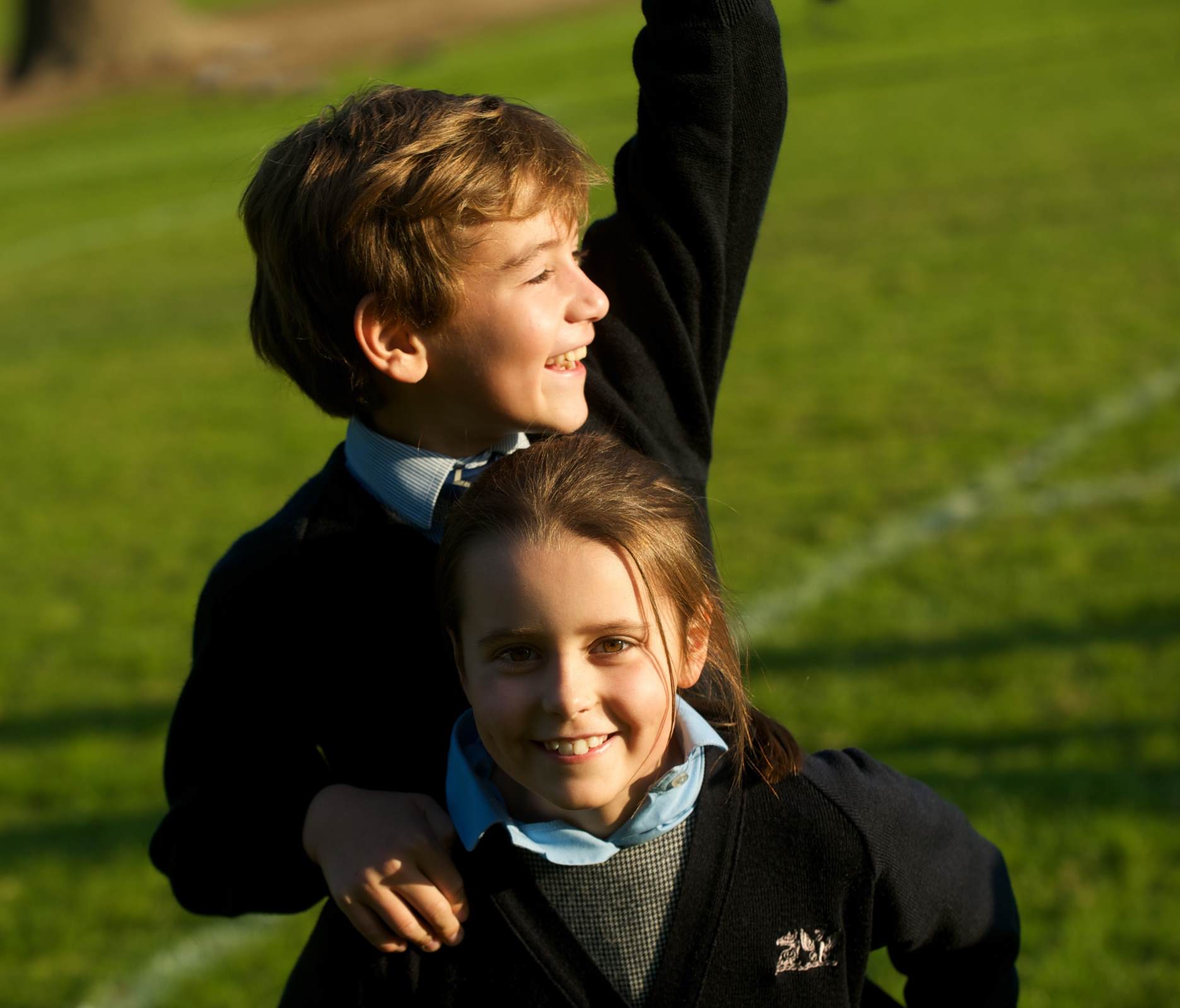 cottesmore school boy and girl pupil wearing uniform smiling happy outside in field