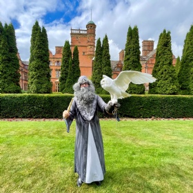 cottesmore school wizard and owl outside on grounds during wizard day