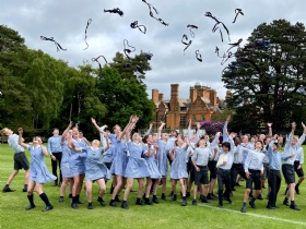 cottesmore school pupils outside throwing their ties in the air