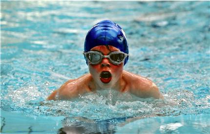 cottesmore school pupil swimming taking breath wearing cap and goggles